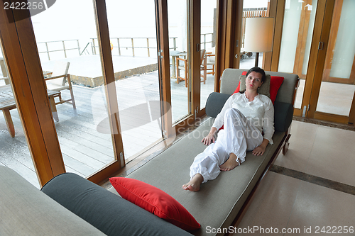 Image of happy young woman relax at home on sofa