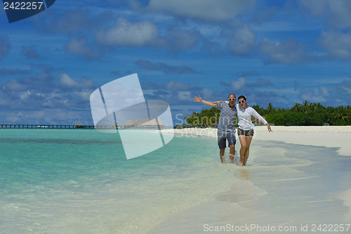 Image of happy young couple have fun on beach