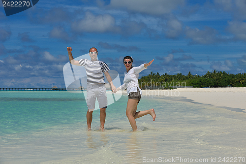 Image of happy young couple have fun on beach