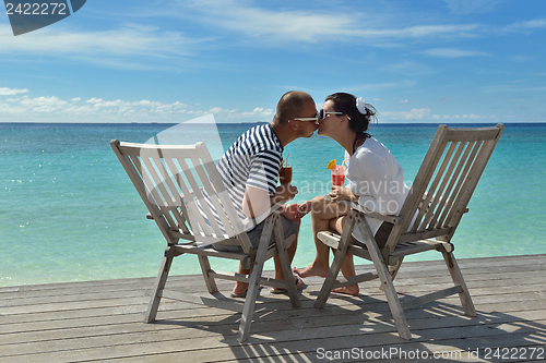 Image of happy young couple relax and take fresh drink