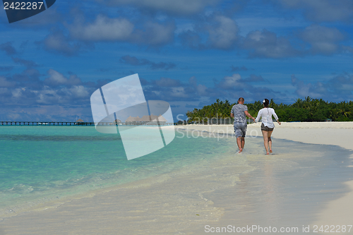 Image of happy young couple have fun on beach