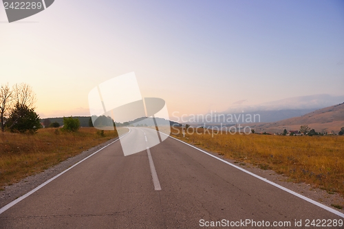 Image of road through the green field