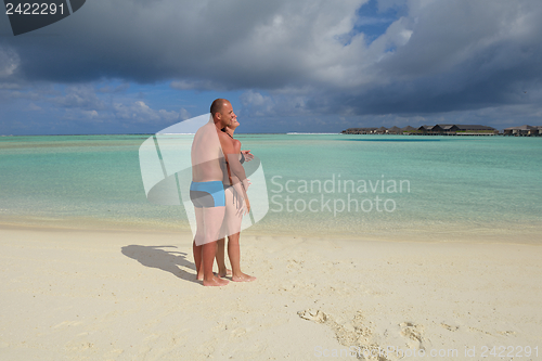 Image of happy young couple have fun on beach