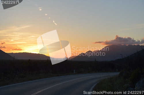 Image of road through the green field