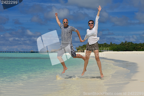 Image of happy young couple have fun on beach