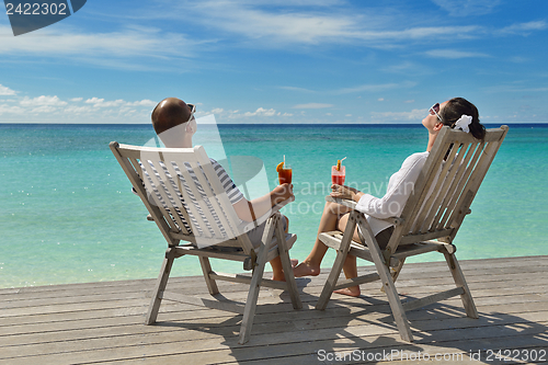 Image of happy young couple relax and take fresh drink