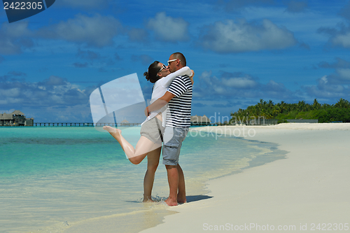 Image of happy young couple have fun on beach