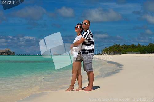 Image of happy young couple have fun on beach