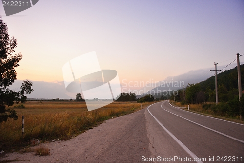 Image of road through the green field