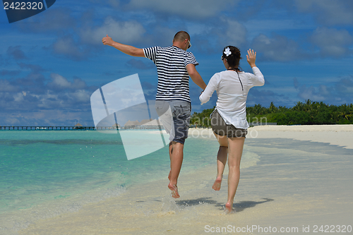 Image of happy young couple have fun on beach