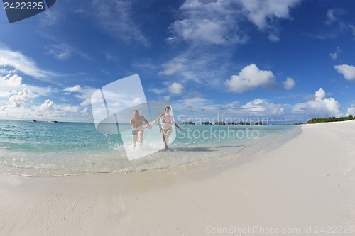 Image of happy young couple have fun on beach