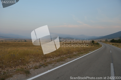 Image of road through the green field