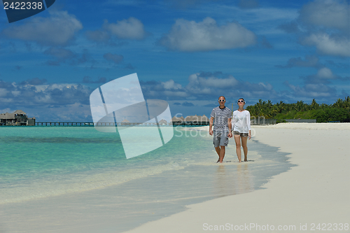 Image of happy young couple have fun on beach