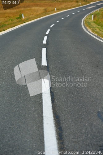 Image of road through the green field