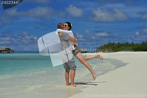 Image of happy young couple have fun on beach