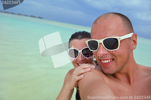 Image of happy young couple have fun on beach