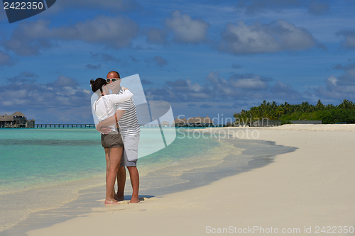 Image of happy young couple have fun on beach