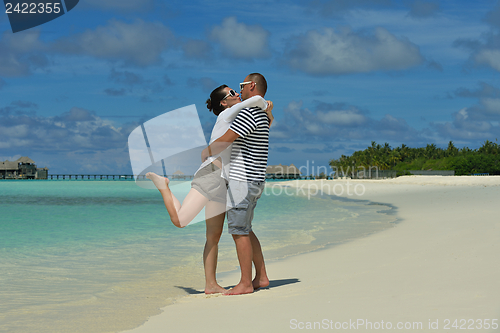 Image of happy young couple have fun on beach