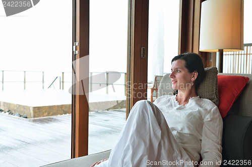 Image of happy young woman relax at home on sofa