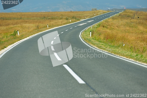 Image of road through the green field