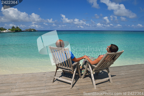 Image of happy young couple have fun on beach