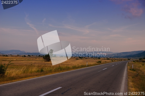 Image of road through the green field