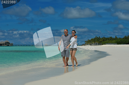 Image of happy young couple have fun on beach