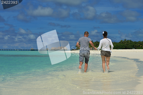 Image of happy young couple have fun on beach