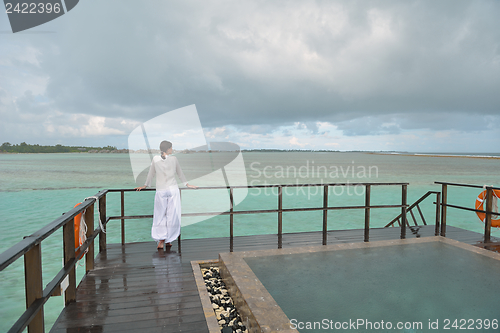 Image of young woman relax on cloudy summer day
