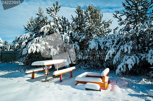 Image of benches with table in the snow