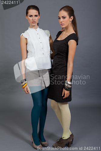 Image of two beutiful brunette girls in casual fashion and accessory 