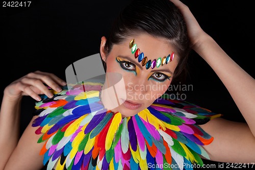 Image of beautiful woman with colorful extreme makeup and accessoires