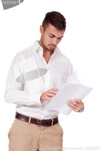 Image of young adult businessman reading document letter isolated