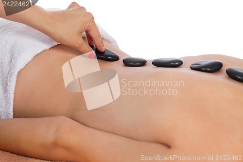 Image of attractive healthy caucasian woman hot stone massage wellness 