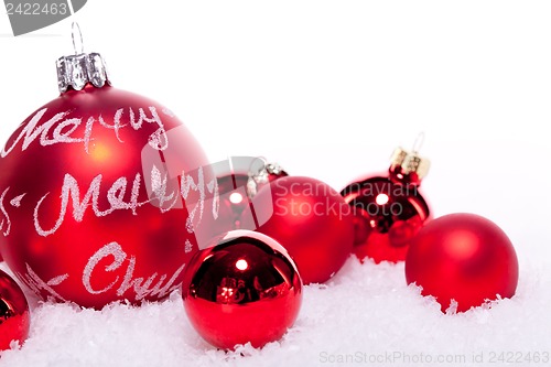 Image of christmas decoration festive red bauble in snow isolated