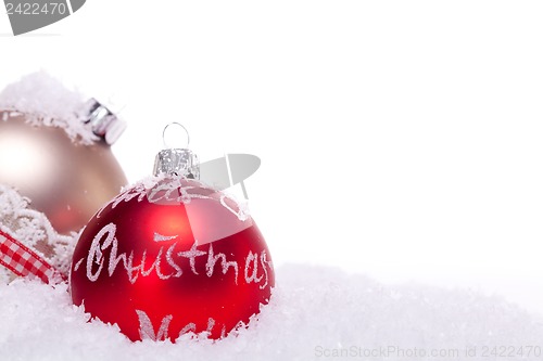 Image of christmas decoration festive red bauble in snow isolated