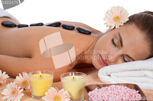 Image of attractive healthy caucasian woman hot stone massage wellness 