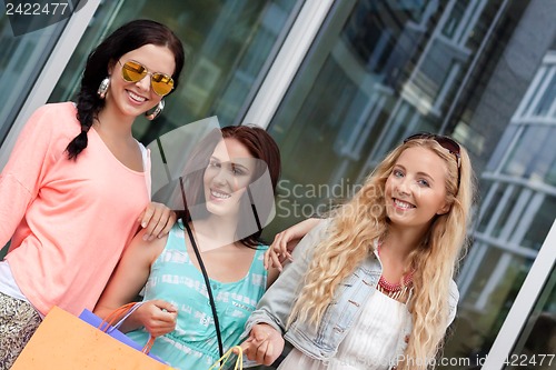 Image of two attractive young girls women on shopping tour