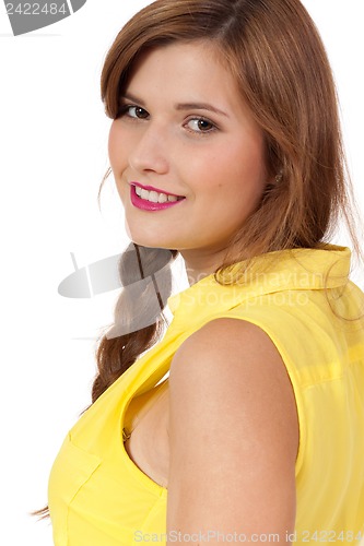 Image of smiling young brunette woman in yellow dress isolated