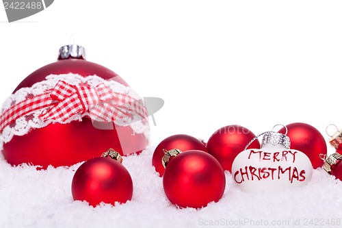 Image of christmas decoration festive red bauble in snow isolated