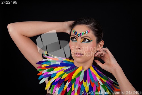 Image of beautiful woman with colorful extreme makeup and accessoires