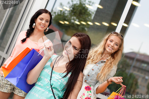 Image of two attractive young girls women on shopping tour