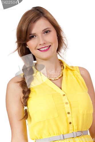 Image of smiling young brunette woman in yellow dress isolated