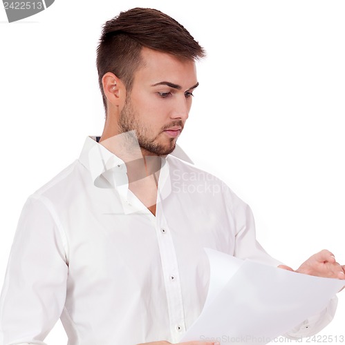 Image of young adult businessman reading document letter isolated