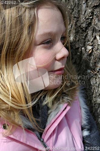 Image of Girl Against a Tree