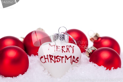 Image of christmas decoration festive red bauble in snow isolated