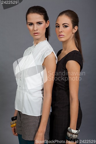 Image of two beutiful brunette girls in casual fashion and accessory 