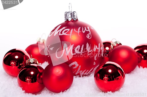 Image of christmas decoration festive red bauble in snow isolated