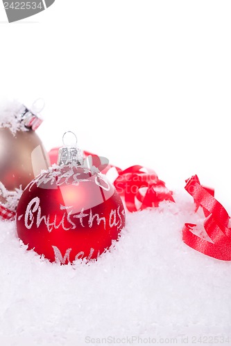 Image of christmas decoration festive red bauble in snow isolated