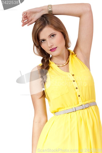 Image of smiling young brunette woman in yellow dress isolated